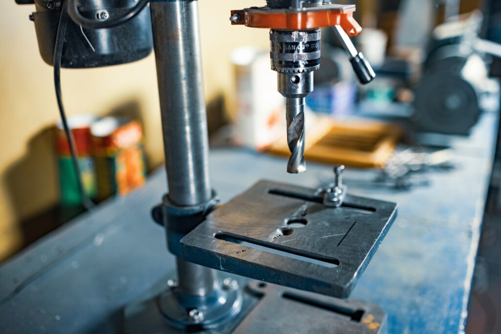 Drilling machine at the workplace in workshop